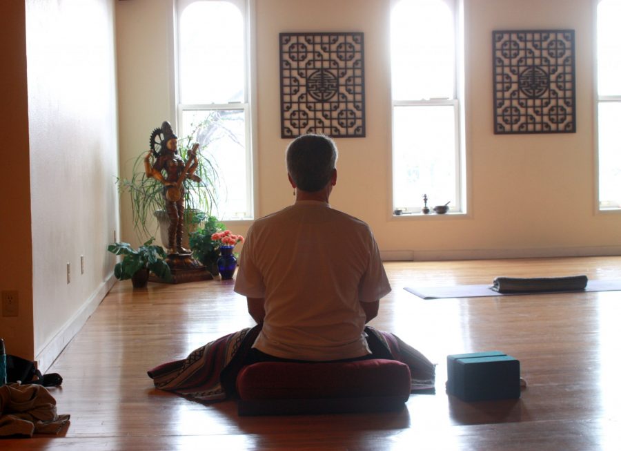 Fort Collins local, Stan Oakland, meditates patiently before the start of a Monday morning yoga class at Om Ananda Yoga. Om Ananda Yoga is one of several yoga venues in Fort Collins that offers donation-based yoga classes in addition to their regular schedule. (Photo credit: Madison Brandt)