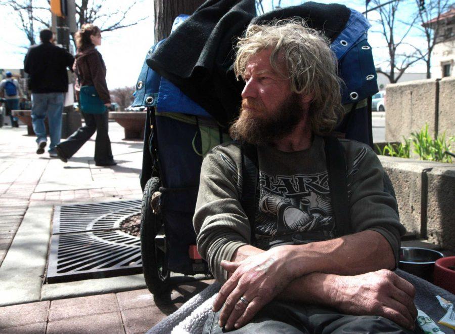 A Fort Collins citizen leans against his backpack on the sidewalk on College Avenue in Old Town March 2015. He believes there are a lot of positive changes that could be made to homelessness policies in Fort Collins, including the transformation of currently unused space in a dedicated lot for people without homes to temporarily stay. (The Collegian file photo)
