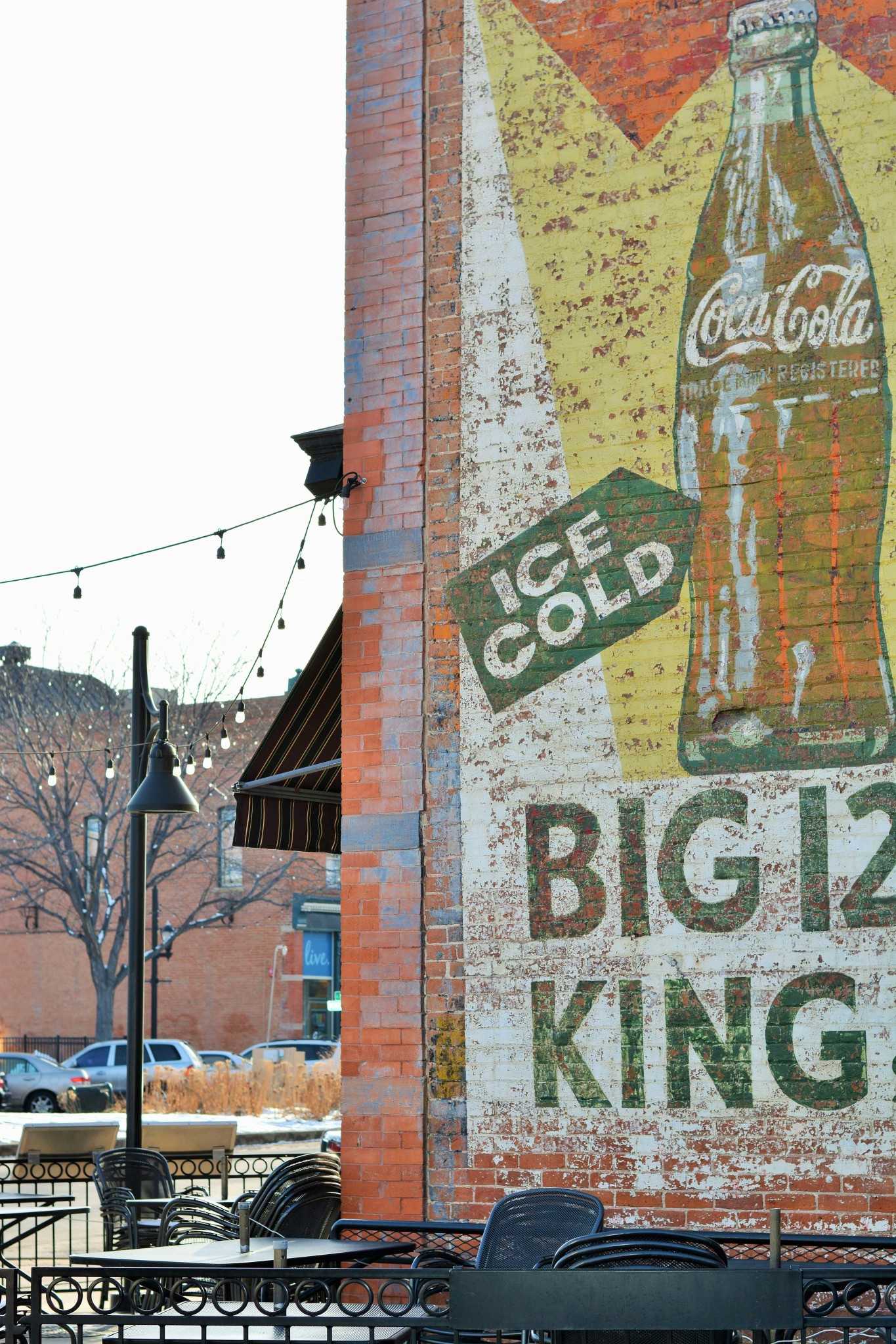 This vintage Coca-Cola mural adorns the side of Cooper Smiths Brewing Company.