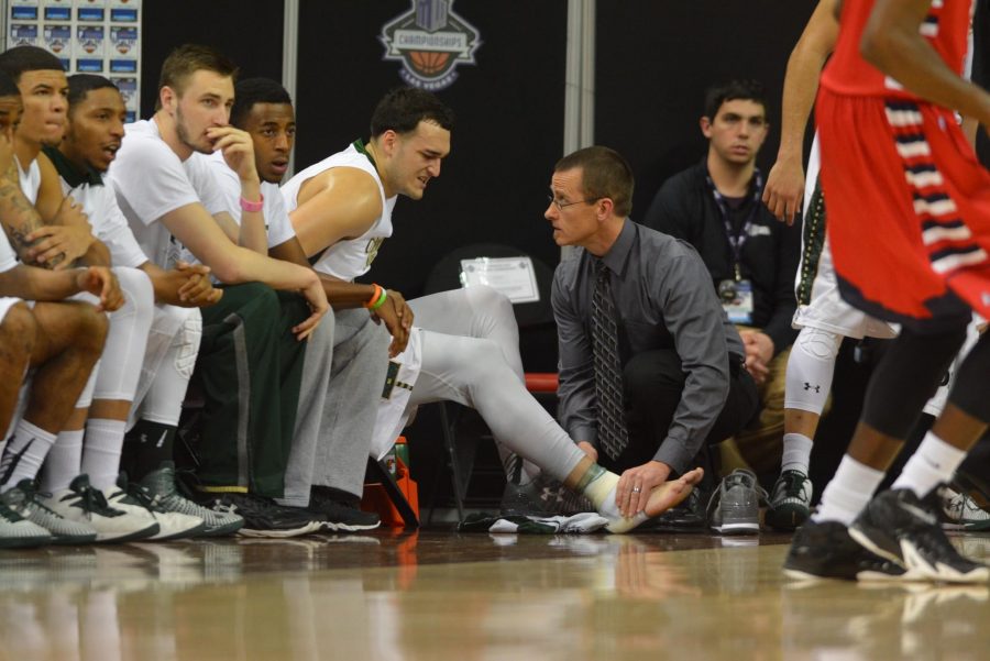 Colorado State forward JJ Avila is attended to by trainers during the Rams' 71-59 win over Fresno State Thursday. (Photo by Keith Albertson)