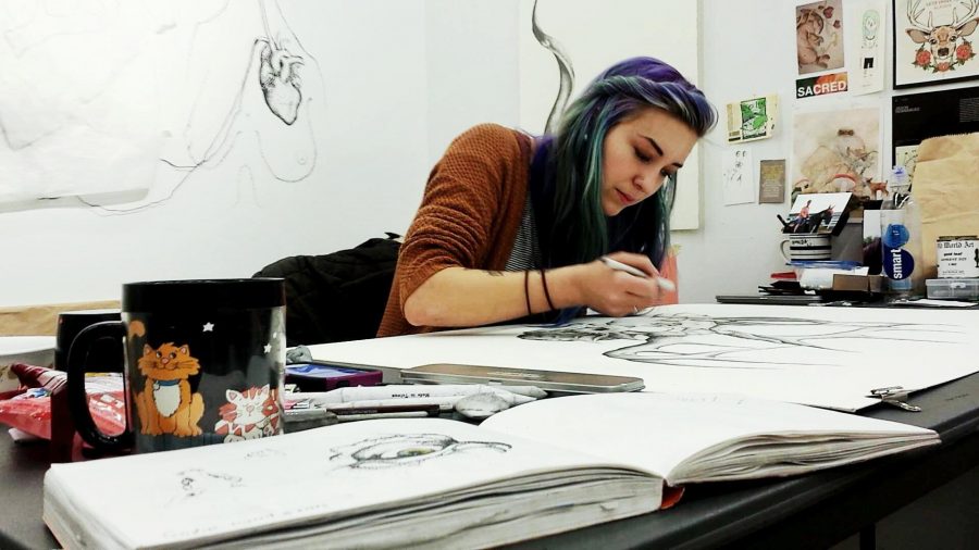Art major Amanda Thomas works in the drawing concentration studio, where she says she spends most of her time. (Photo Credits: Hannah Ditzenberger) 