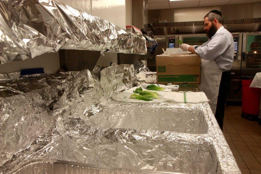 Rabbi Yerachmiel Gorelik took two hours Thursday morning to sanitize the Colorado State University LSC kitchen in order for it to be Kosher friendly As Rabbi Yerachmiel Gorelik explains, the double layer of tin foil prevents cross contamination and ensures the safety of the food being prepared. The food prepared on Thursday is for a Passover event being held in the LSC tomorrow evening. (Photo credit: Madison Brandt)