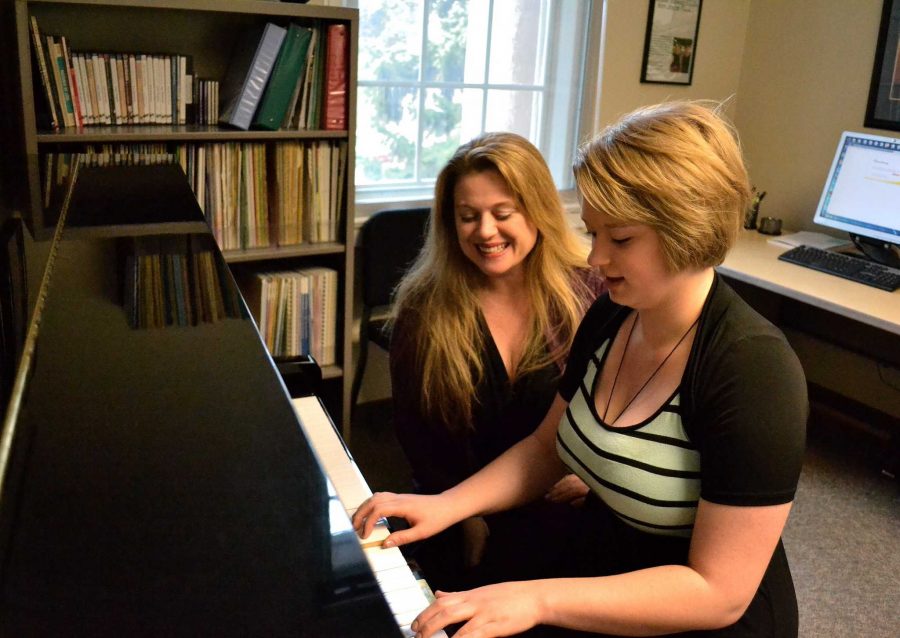 Professor Apodaca glances over her private student Mattie Beckers shoulder as she plays For Elise by Beethoven in her office at the UCA.