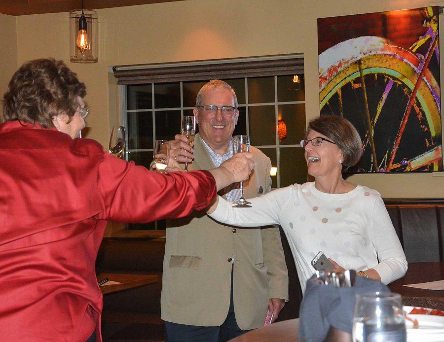 Newly-elected mayor Wade Troxell toasts his wife Jean Troxell, and current mayor, Karen Weitkunat, after finding out that he won the election. (Photo credit: Ellie Mulder)