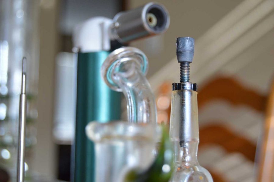 When using a dab rig, there are several necessities: a dabber, a torch, dome, nail and the rig. (Photo credit: Lawrence Lam)
