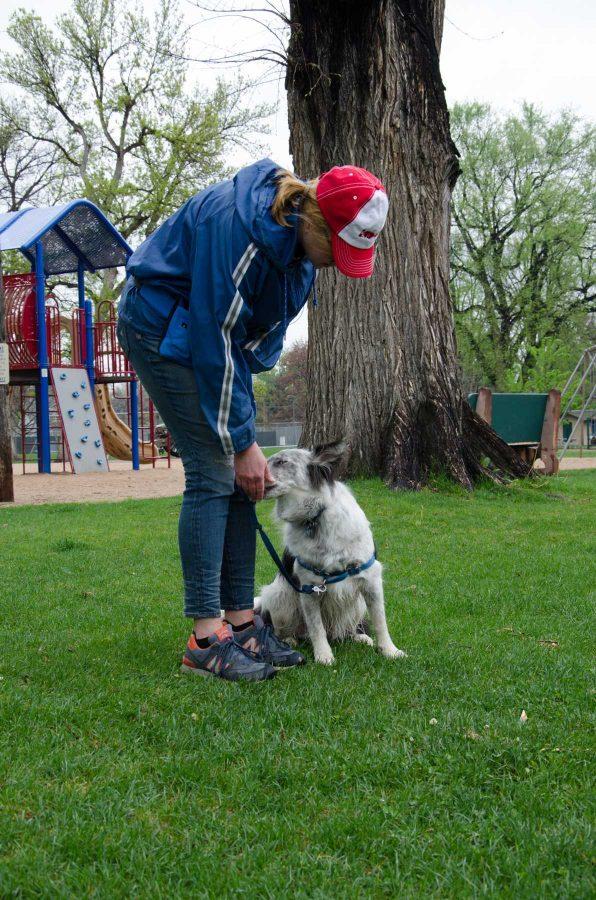 Heather Wilkinson, an editor at Selene River Press takes her 3-year-old Aussie Shepard mix named Critter for a walk in City Park despite the rainy weather on Monday.