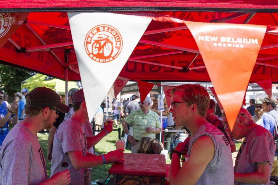 Kevin Figurski serves beer to festival-goers as a volunteer at the Brewers Festival.   