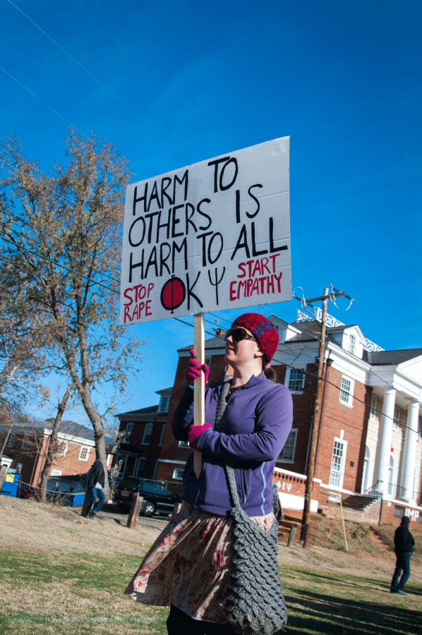 A protestor stands outside the Phi Kappa Psi chapter house at the University of Virginia. (Photo Courtesy: Wikipedia)