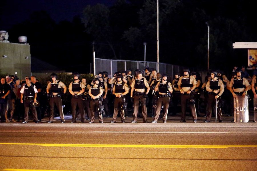 Police line a street in Ferguson, Mo., on Monday, Aug. 10, 2015. A state of emergency was declared for Ferguson and the rest of St. Louis County Monday following a gun battle between police and protesters Sunday night on the anniversary of Michael Brown's death. (Jim Vondruska/Xinhua/Sipa USA/TNS)