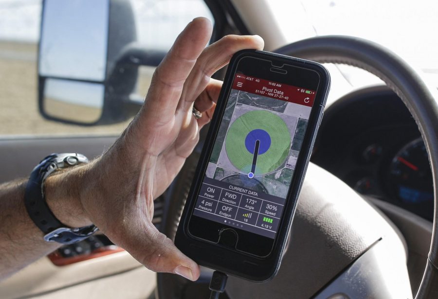 Brant Peterson uses his iPhone to check his irrigation pivots in his farm on June 10, 2015 in Stanton County, Kan. Peterson says he's noticed that the Ogallala aquifer, from which he draws to irrigate his crops, has declined rapidly in recent years as Kansas experienced a drought. His farm got just seven inches of rain a year for six years. During that time, the water level in his wells dropped by more than half. 