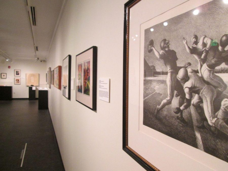 Photos lining the walls at Scrimmage: Football in American Art from the Civil War to the Present at the University Art Museum. (Photo credits: Rachel Fountain)