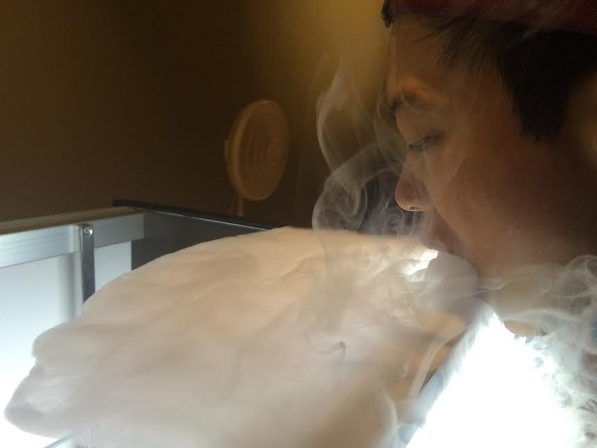 Narghile Nights employee creates a lake of vapor that will be used for smoke tricks, a popular reason for people to begin vaping.