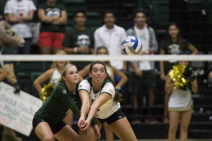 CSU seniors Jaime Colaizzi (left) and Alex Reid (right) team up for a dig years after their high school rivalry.