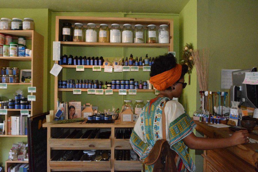 Kesha Ladd purchases a house made herbal tea blend Wednesday at Golden Poppy Herbal Apothecary, located on 212 S. Mason St. 
