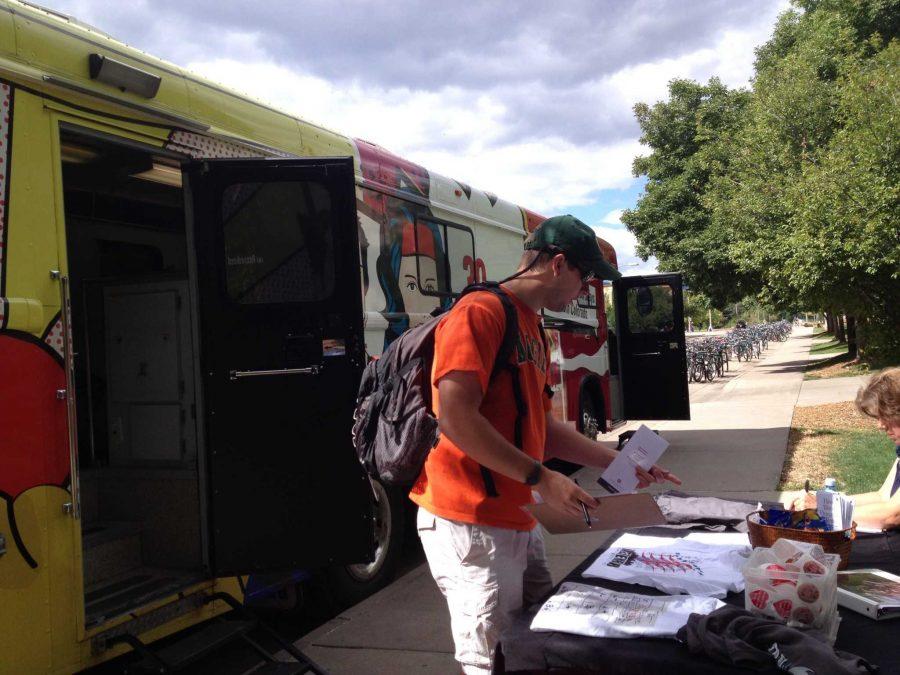 A student checks in to donate blood at the Garth Englund van. (Photo by: Julia Rentsch).