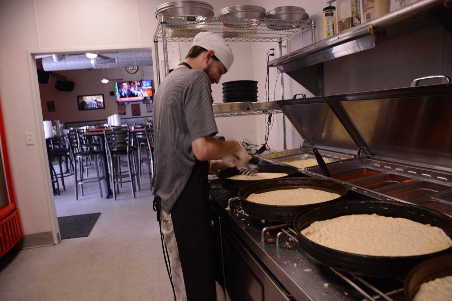 Krazy Karl's Pizza employee James Gilbert prepares several pizzas Monday afternoon. Gilbet said he likes the work environment in the pizza shop because the people are fun to work with and the work environment is laid back but he has enough work to keep him busy. (Photo Credit: Megan Fischer).