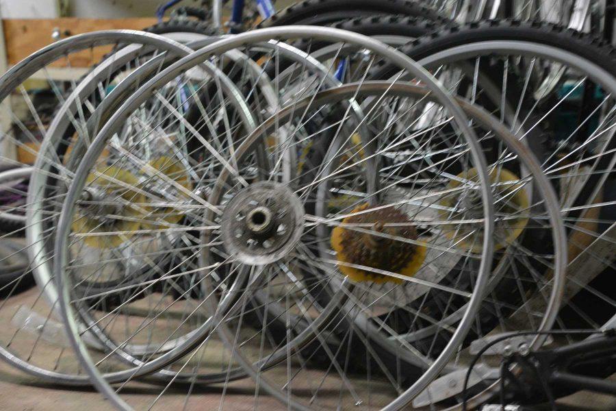 A set of bike wheels sits in the Fort Collins Bike Co-op. Recovered and abandoned bikes are sometimes taken apart and used to make other bikes, or for cheap replacement parts. (Photo by: Megan Fischer)