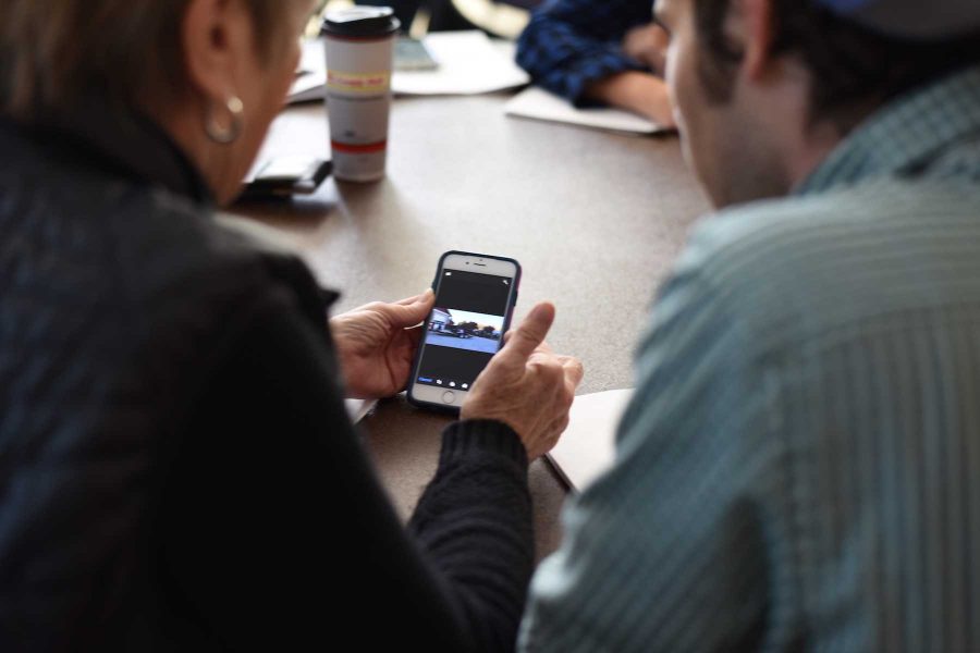 CSU student Jack Carlson helps Fort Collins citizen with her iPhone October 31, 2015. (Collegian File Photo)
