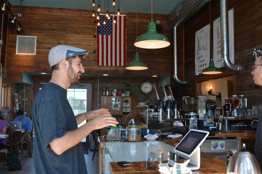 Cameron Trezoglou, CSU alum, makes a purchase at Bindle Coffee. Trezoglou works at the Farmhouse at Jessup Farm.