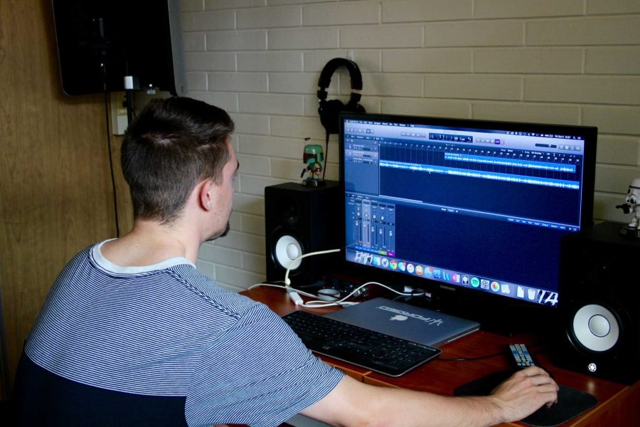 Josh Weemes, also known as Emprovyze, reviews a recording in his studio he built in Corbett Hall.