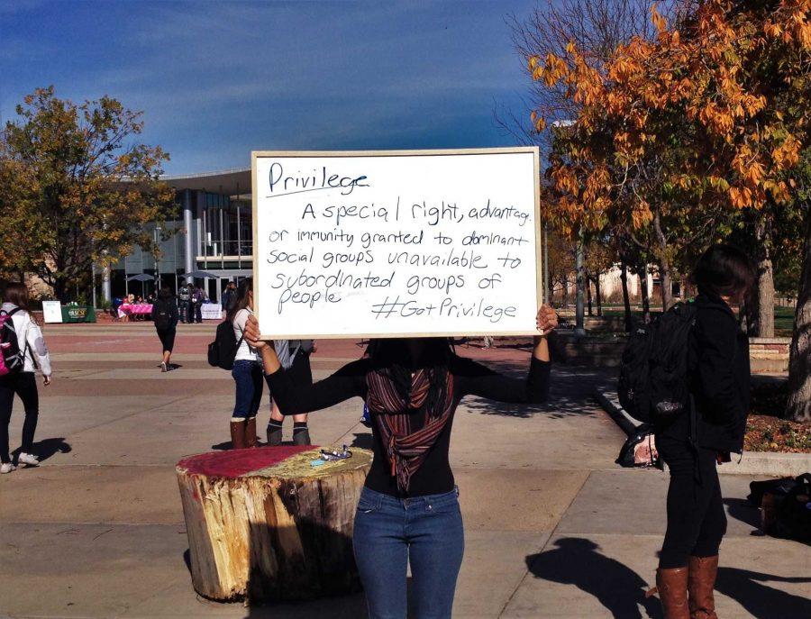 A student demonstrator, who wished to remain anonymous, holds up the definition of privilege. (Photo credit: Julia Rentsch).