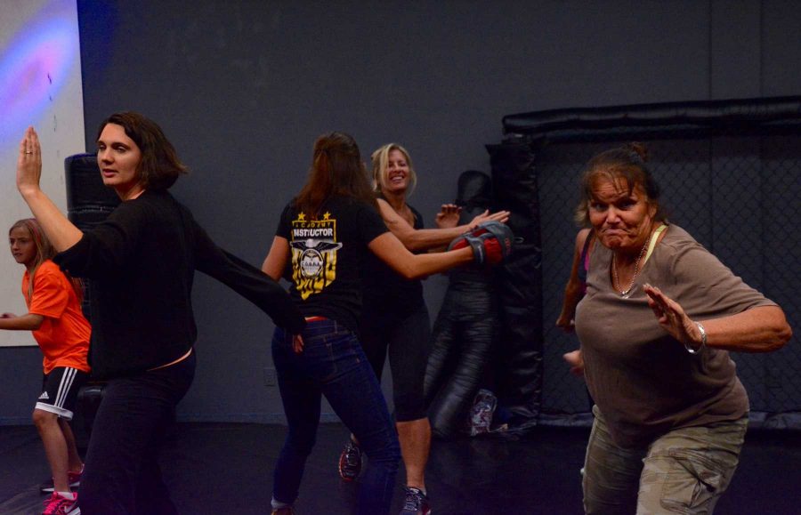 Students practice palm strikes during a self-defense class Monday. (Photo Credit: Megan Fischer)