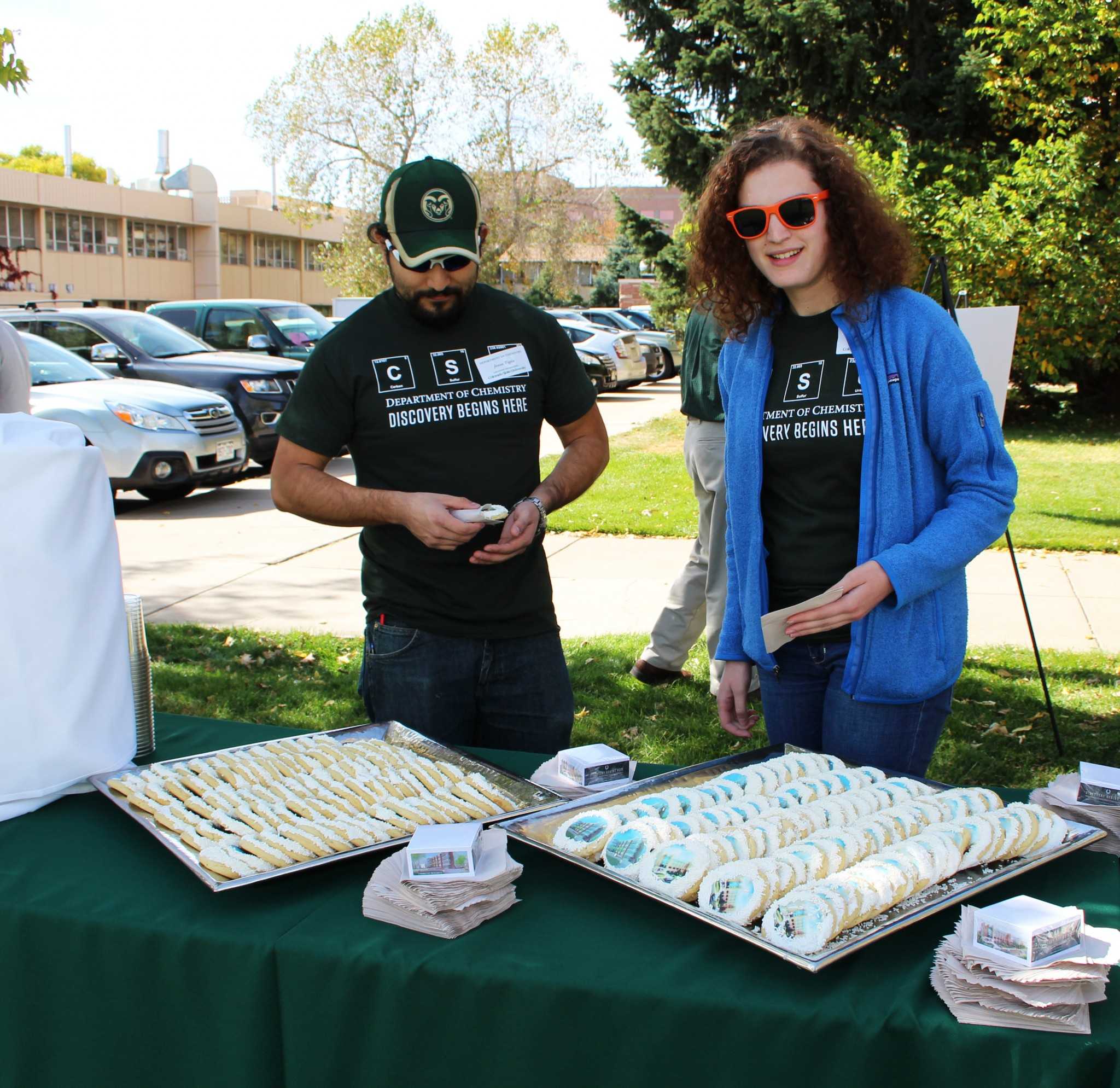 Kathryn Tracy and Jesus Tapia, chemistry graduate students, treat themselves to cookies decorated with a picture of the new Chemistry Research Building.