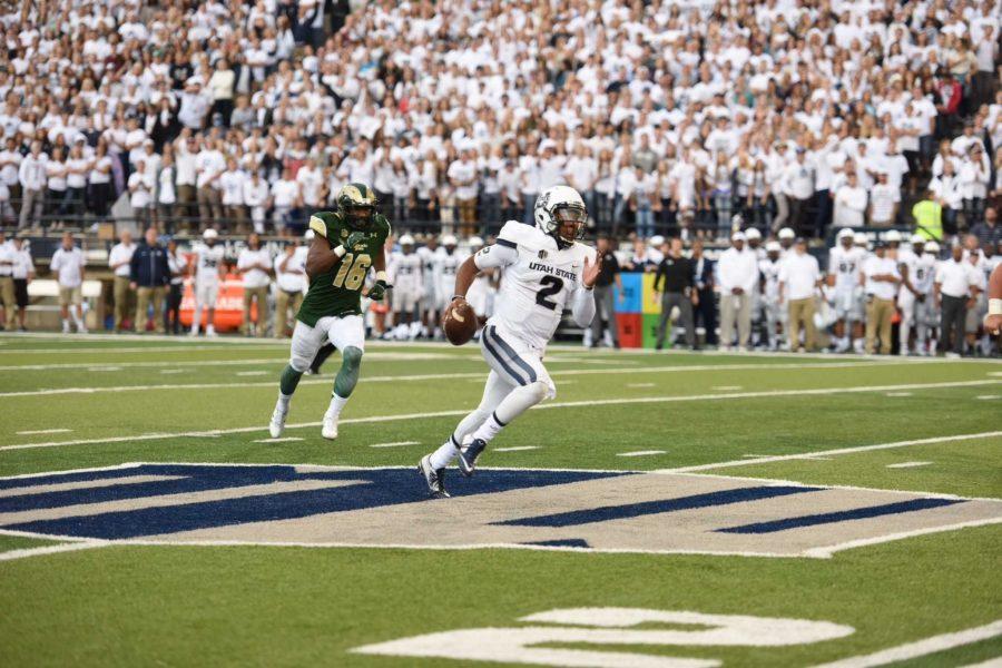 Utah State quarterback Kent Myers escapes CSU defender Trent Matthews during Saturday's game at Maverik Stadium. (Photo Courtesy: The Utah Statesman) 