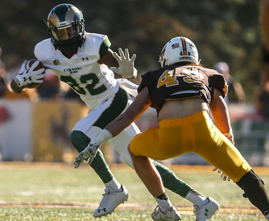 Rashard Higgins about to stiff arm a Wyoming defender during 26-7 Border War win. (Photo by Abbie Parr)