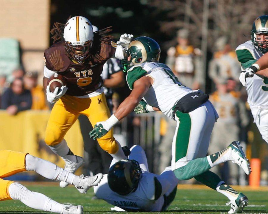 Colorado State linebacker Kiel Robinson, right, tackles Wyoming running back Brian Hill during the Rams' 26-7 win over the Cowboys Saturday at War Memorial Stadium. (Abbie Parr/Collegian)