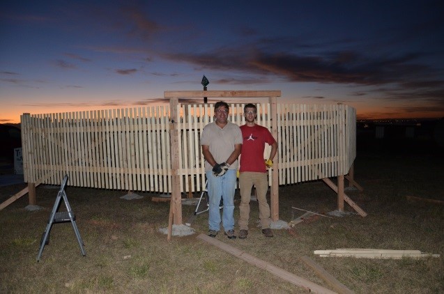 Cameron Kleinkort, right, and his advisor Dr. Branislav Notaros stand in front of their wind fence around their snowflake camera setup (Photo courtesy of Branislav Notaros). 