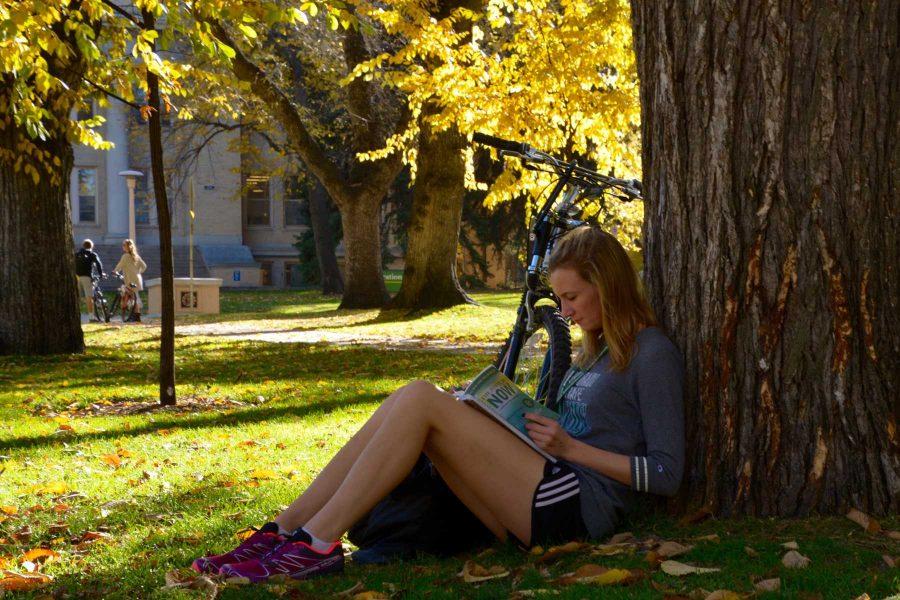 Junior environmental health major, Kristan Coggins, relaxes in the shade among the colorful leaves as she takes a break from studyng for a test. (Photo Credit: Megan Fischer)