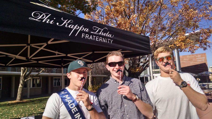 Phi Kappa Theta members Shane McKillip, Liam Aubrey, Zach Kugler promote Movember at their booth on the plaza. (Photo Credits Rachel Fountain)