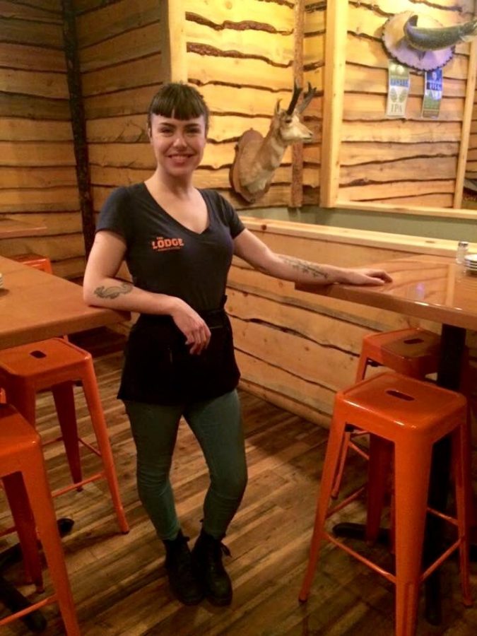 Linda Baylor shows off her tattoos during a Sunday morning serving shift at The Lodge Sasquatch Kitchen. Photo taken by Laurel Thompson. 