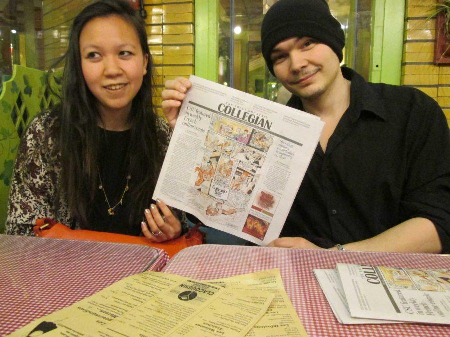 Thivone and Aubert pose with their first article in the Collegian outside a bistro in Paris. Two students studying abroad in the spring 2015 semester were able to deliver copies of the article to the comics creators. (Photo Credits: Rachel Fountain) 
