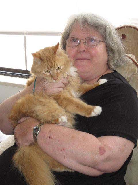 A Pets Forever program participant poses with her cat. (Photo courtesy of Pets Forever.)