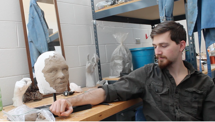 Sebastian Smith in the studio with one of his pieces (Photo Credit: Seth Bodine.)