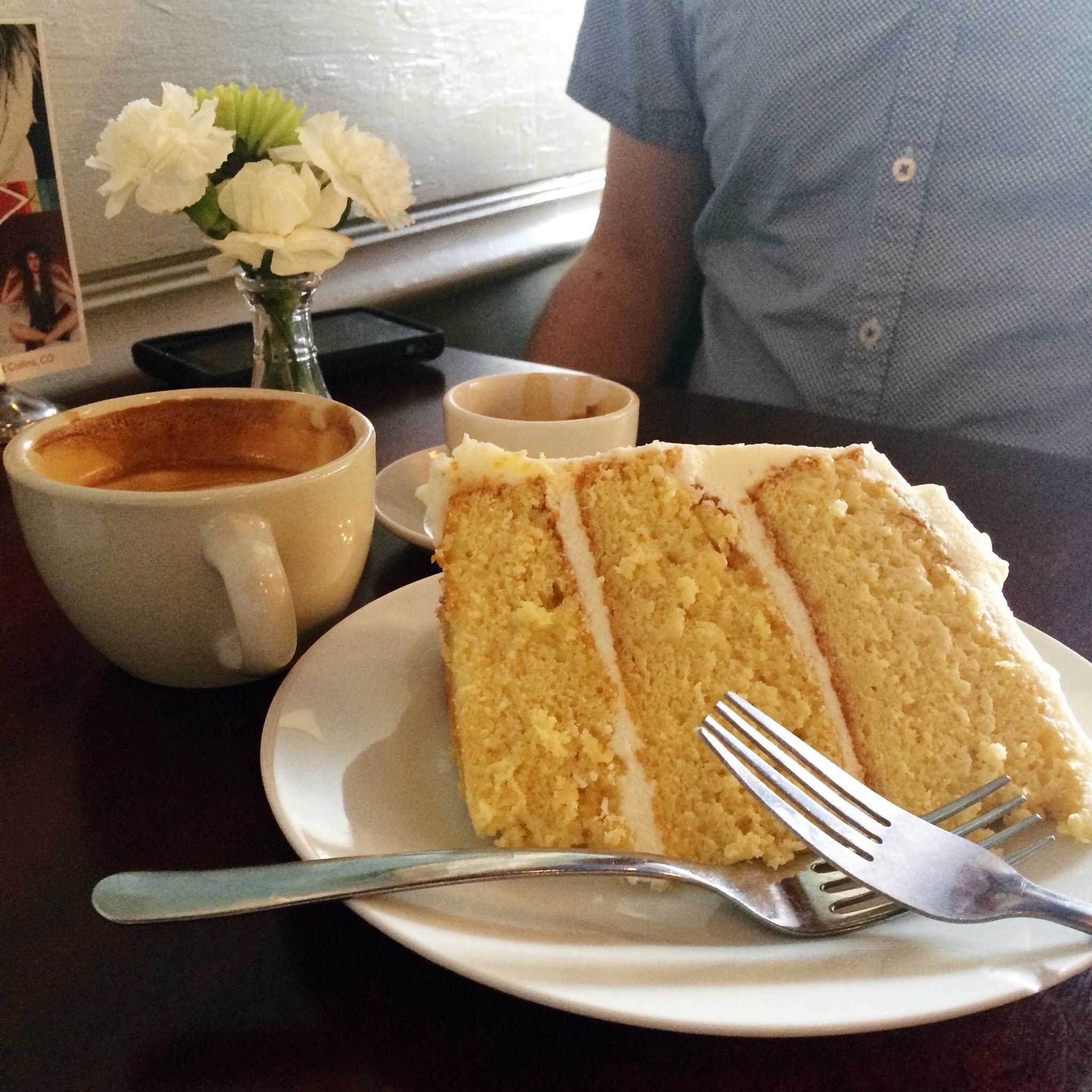 A slice of lemon cake along with a latte and an espresso. Photo by Rachael Worthington.