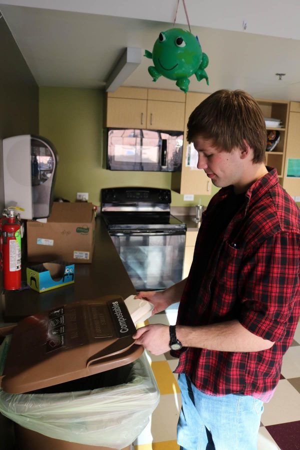 Freshman construction management student Jake Simmons composts his lunch container in Piñon Hall, a research hall for composting facilities for future residence halls. 