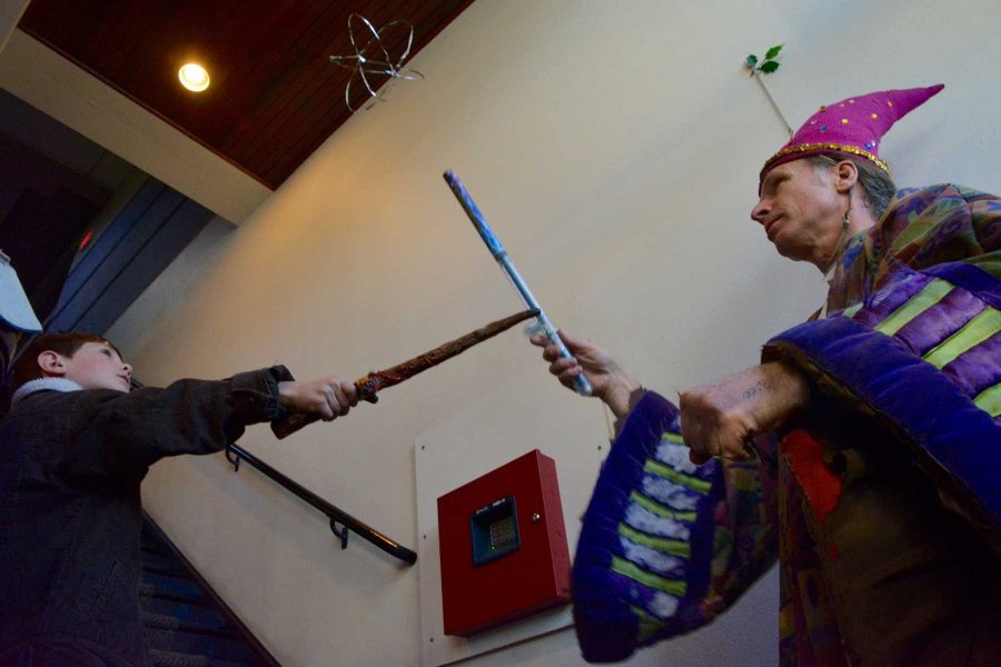 River Carson, 8, (left) and Matt Hanifin (right) move an object around in the air with wands. Hanifin is is owner of Science Toy Magic in Old Town, Fort Collins. (Photo Credit: Megan Fischer)