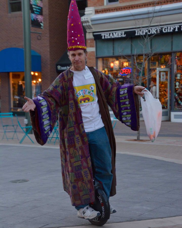 Matt Hanifin, owner of Science Toy Magic in Old Town, Fort Collins, whirls around Old Town square before showing some of the science toys from his shop. (Photo Credit: Megan Fischer)