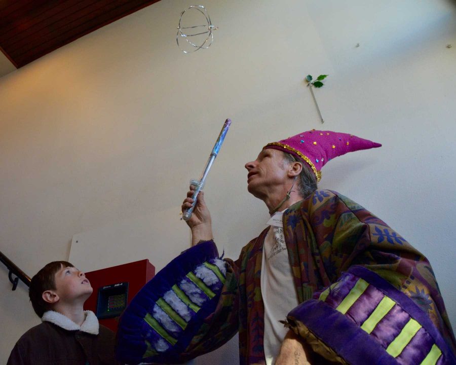 River Carson, 8, (left) watches as Matt Hanifin moves an object around in the air with a wand. Hanifin is is owner of Science Toy Magic in Old Town, Fort Collins. (Photo Credit: Megan Fischer)
