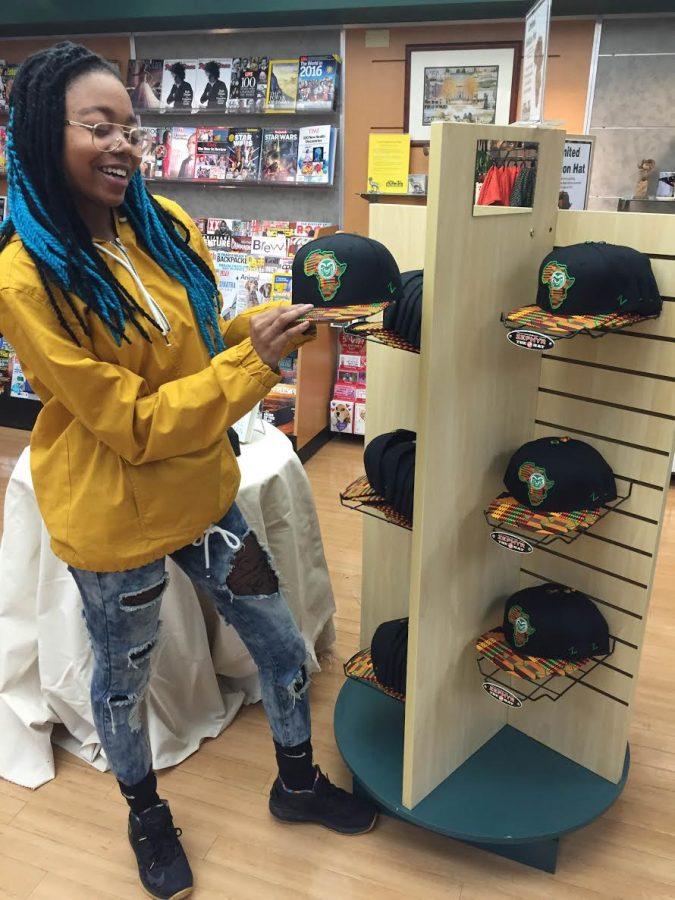 checks out the hats she designed in the CSU Bookstore. (Photo courtesy of Alexis Works.)