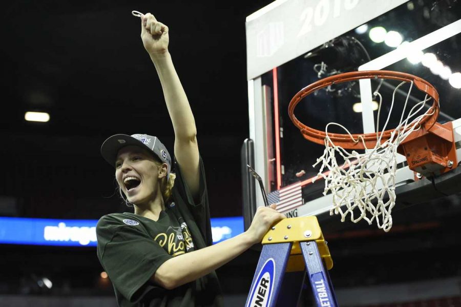 Moutain West Player of the Year Ellen Nystrom cuts down the nets in the Thomas and Mack center after defeating Fresno State in the MW tournament finals. (Steve Nowland/NCAA Photos)
