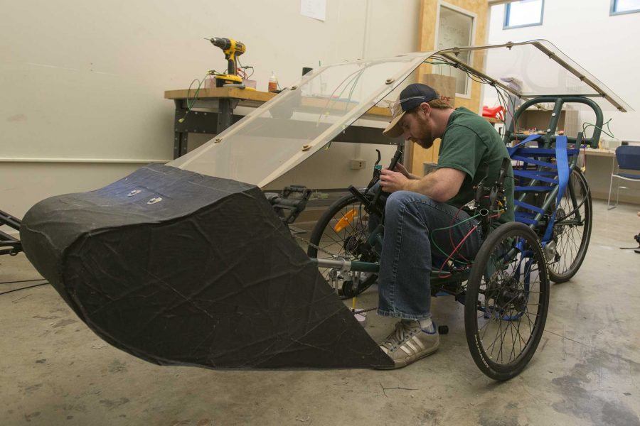 Brett Goldfarb a senior mechanical engineer makes last minute adjustments on a human powered vehicle. They are going to  be one of the projects presenting at engineering days 2016 and are competing a week later in California. (Luke Walker/ The Collegian)
