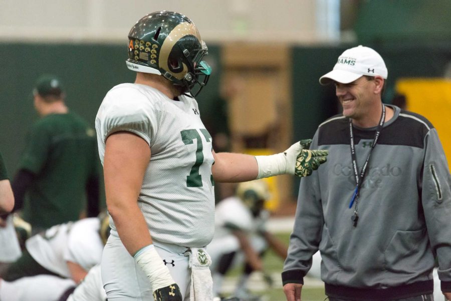 Jake Bennett talks with CSU coach Mike Bobo during a spring practice in 2017. (Luke Walker | Collegian)