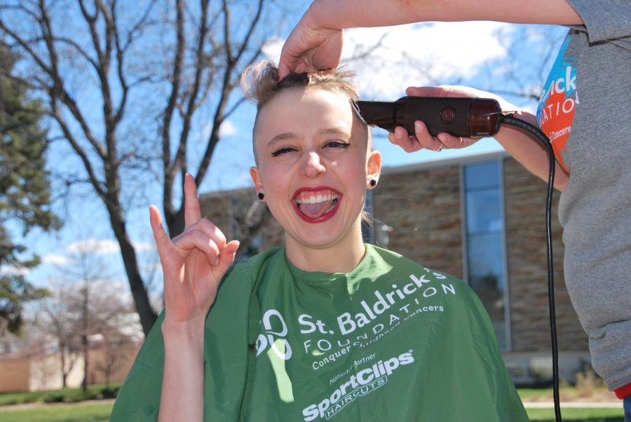 Michelle Moyer, a senior zoology major, gets her head shaved at CSU's St. Baldrick's event Friday. (Photo by Emily Hendrickson.)