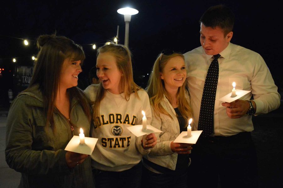 From left: seniors Jane Schwartz, Amanda Castle, Karli Nash and Zach Yarnell embrace at the senior candlelight celebration on the steps of the Administration building during the last week of classes for Colorado State University. (Photo by: Megan Fischer)