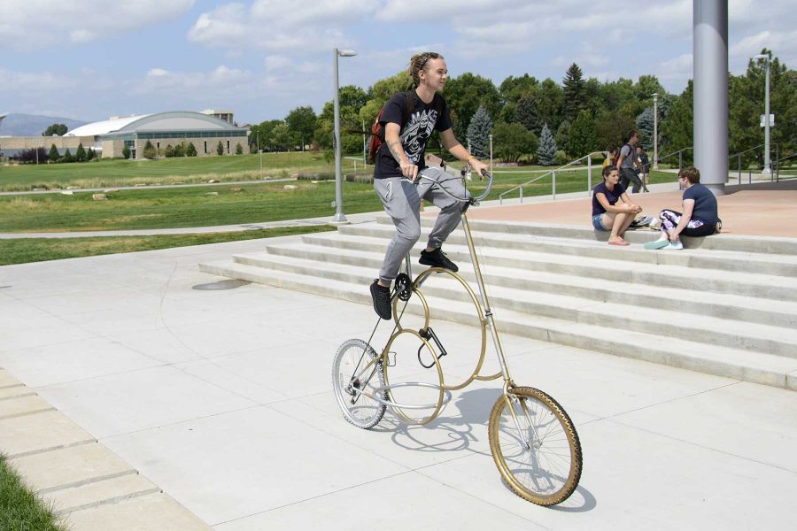 Dylan Johnson rides his custom made bicycle past the Lory Student Center on August 31st, 2016. Photo credit: Luke Walker