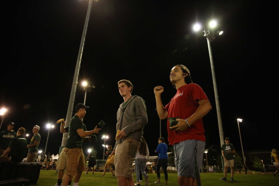 Richie Dow, right, and Christian Kelly, left, react as Dow makes a shot while playing a game of corn hole on the first night of Ram Welcome activities on Thursday, August 18th. The Ram Welcome weekend featured carnival rides, games, music, and many other activities for incoming CSU freshman to participate in during their first week at Colorado State University. (Forrest Czarnecki/Collegian)